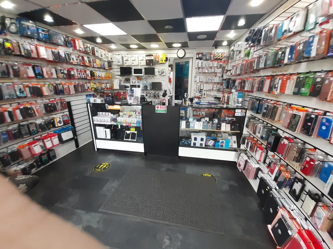 Inside Yorkshire Tech Centre, with phones and accessories displayed along the walls and counter